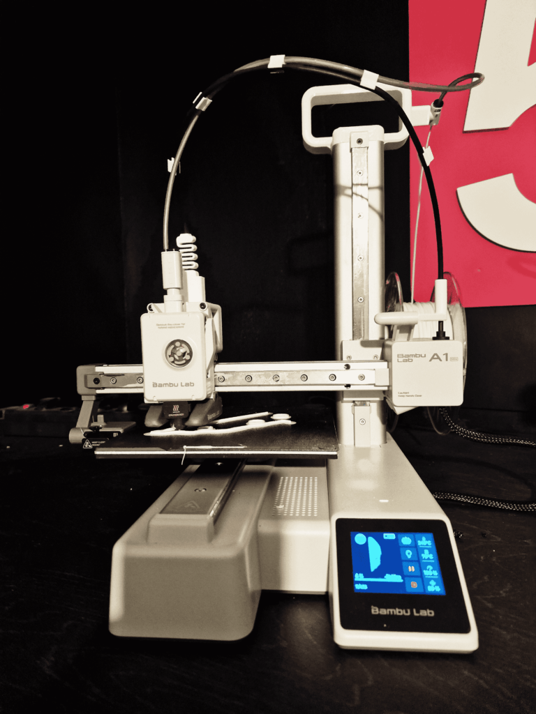 Close-up of the Bambu Lab A1 Mini, an Easy to Use 3D Printer, producing a detailed print for new users