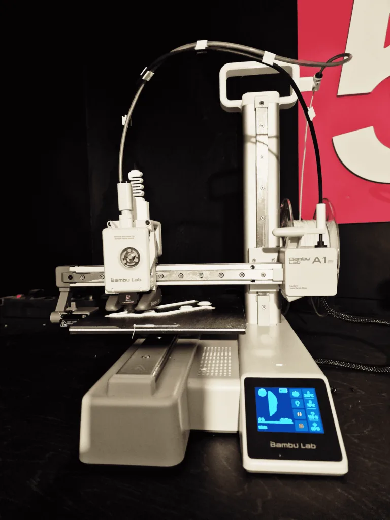 Close-up of the Bambu Lab A1 Mini, an Easy to Use 3D Printer, producing a detailed print for new users
