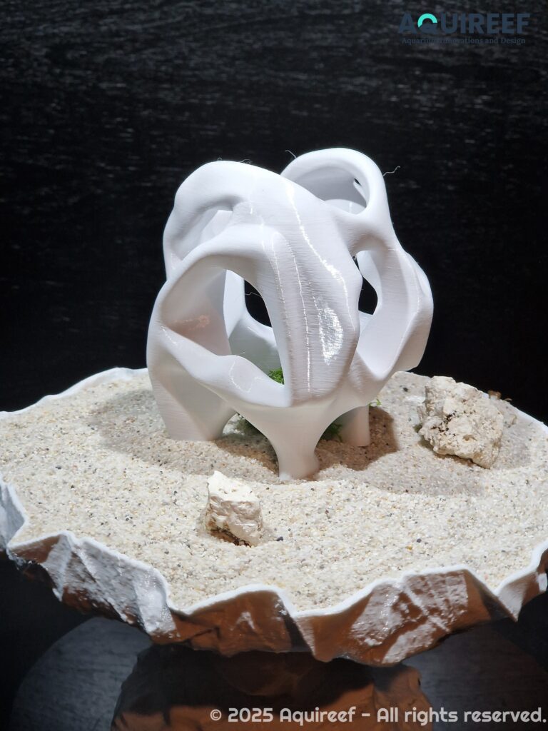 A side view of a cichlid unique design cave showcased on sand soil. Smooth edges safeguard the fish swimming through it. A design by AquireefęD